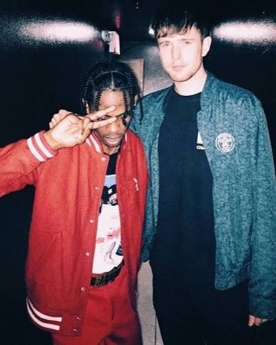 Travis Scott and James Blake standing together