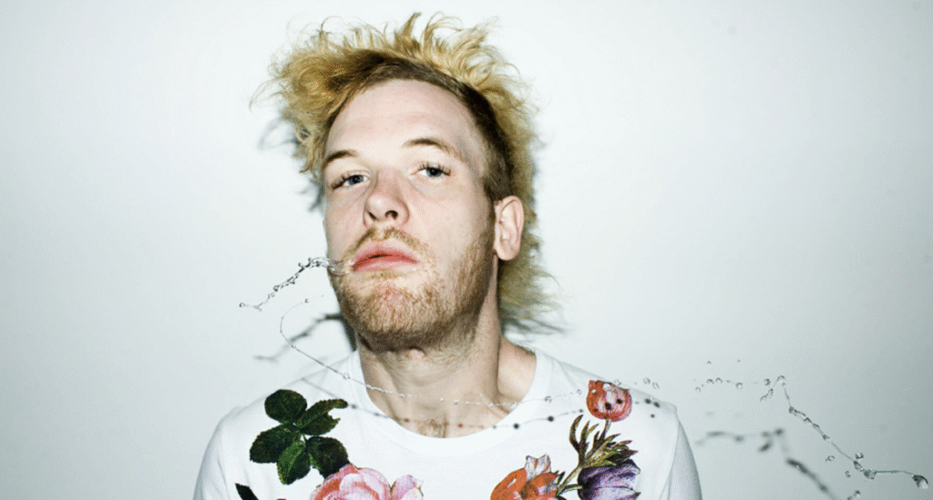 DJ Rusko mixing music while wearing a funny bird mask